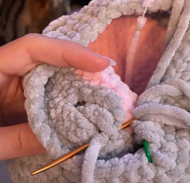 sewing the fins to the crochet turtle