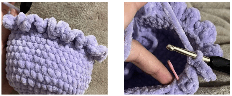 Crochet work-in-progress showing the jellyfish head body with a stitch marker and crochet hook during amigurumi assembly.