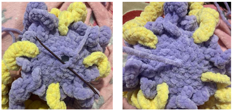 Crochet work-in-progress showing the jellyfish head body with a stitch marker and crochet hook during amigurumi assembly.