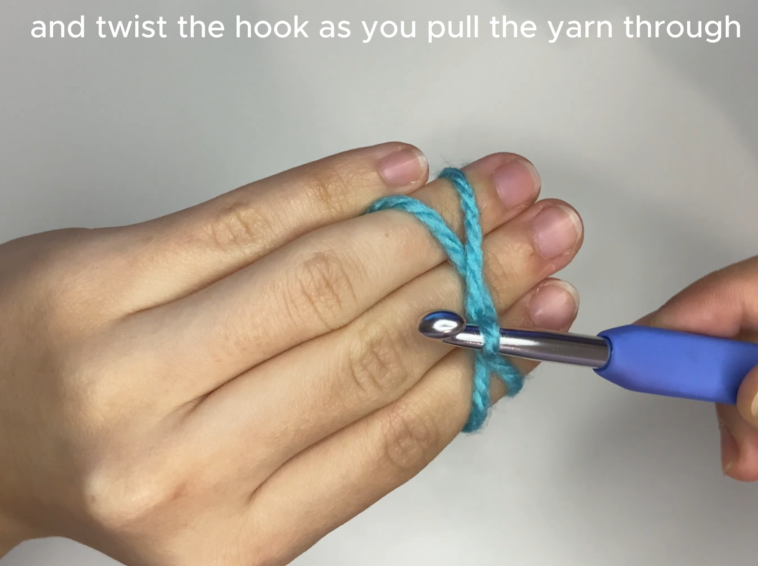 Inserting crochet hook under and over yarn strands to create a magic circle loop.