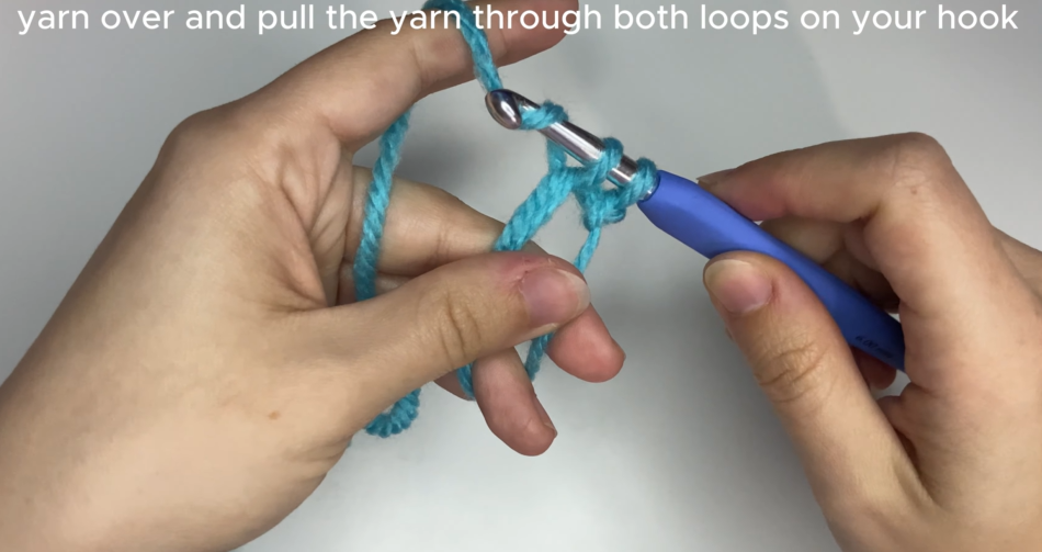 Working single crochet stitches into the center of an adjustable magic ring.