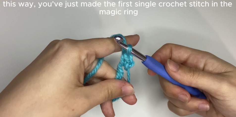 Working single crochet stitches into the center of an adjustable magic ring.