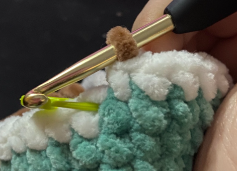 Step by step crochet duck head in green yarn showing color change to white ring and brown body.
