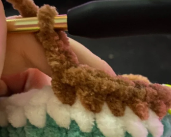 Step by step crochet duck head in green yarn showing color change to white ring and brown body.