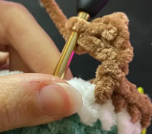 Step by step crochet duck head in green yarn showing color change to white ring and brown body.