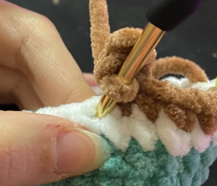 Step by step crochet duck head in green yarn showing color change to white ring and brown body.