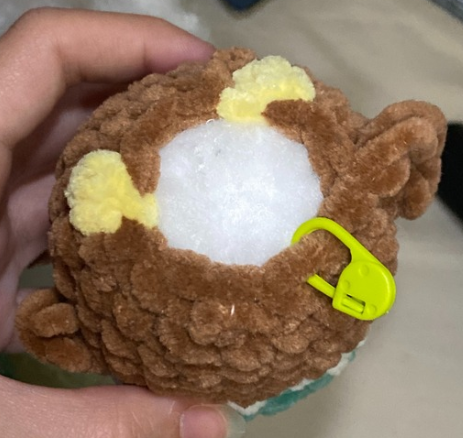 Stuffing plush amigurumi duck body with fiberfill and closing bottom stitches through front loops only.