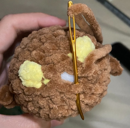 Stuffing plush amigurumi duck body with fiberfill and closing bottom stitches through front loops only.